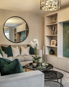 a living room filled with furniture and a round mirror