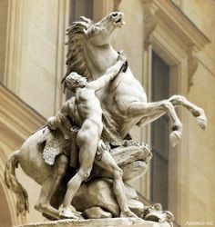 a statue of two men riding horses in front of a building