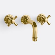 two gold faucets with cross handles and nozzles on each side, one is