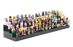 a large group of toy figurines sitting on top of a black display case