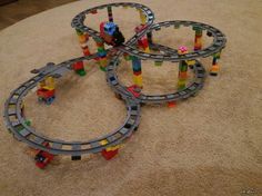 three toy train tracks sitting on top of a rug