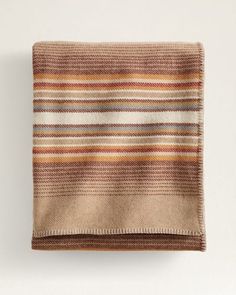 a brown and white striped blanket on top of a table