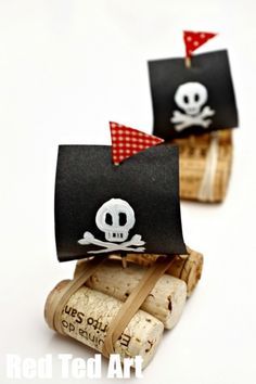 two wine corks with pirate flags on them and a skull in the top one