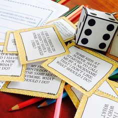 dices and pencils on a table next to some cards with words written in them