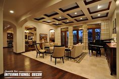 a living room filled with furniture and a piano in the middle of an open floor plan