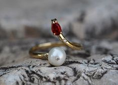 14k gold ring with pearl, garnet. Open ended ring. Adjustable ring. Pear garnet ring. Pearl ring. January and June  birthstone jewelry. By Daizy Jewellery. Ring has a free size. Weight: 1.70 g. Main stone - cultured Akoya Pearl White color, round cut, 6.2 mm size. Diamonds: 0.03 ct (3 x 0.01 ct), round brilliant cut, G/VS. Garnet: purplish red color, pear cut, transparent, 0.60 ct. 💍This ring will be made for order 💍Processing time for custom item takes: 5-7 working days. 💍 It could be done i Garnet Open Ring Jewelry For Wedding, Garnet Birthstone Open Ring, Classic Pearl Ring With Gemstone, Open Ring Design, Pearl And Garnet Ring, Pearl Ruby Ring, Garnet Gemstone Open Ring, Gold Ring With Pearl, Garnet Pearl Ring, Adjustable Gold Ring