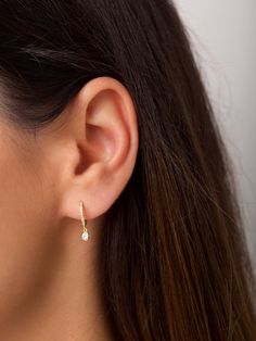 "Perfectly delicate pavé hoop earrings with a tiny white zirconia gemstone drop charm. A versatile and elegant pair that looks beautiful layered with other dainty earrings, but is also perfect worn alone for a more minimal look. ∙ Sold as a PAIR * D E T A I L S * ∙ Material: .925 Sterling Silver or 18K Gold Plated over .925 Sterling Silver ∙ Dimensions: Outer diameter: 12mm // Inner diameter: 8.5mm ∙ Hypoallergenic & nickel-free * P A C K A G I N G * ∙ All jewelry is sent out beautifully pac Small Huggies Earrings, Simple Small Dangle Earrings, Dainty Silver Earring, White Gold Small Earrings, Small Dainty Earrings, Simple Dainty Earrings, Delicate Earrings Gold, Classic Earrings Simple, Dainty Teardrop Huggie Earrings