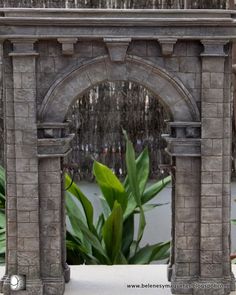 an arch made out of bricks with plants in the background