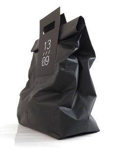 a black paper bag with the number thirteen printed on it's front and side