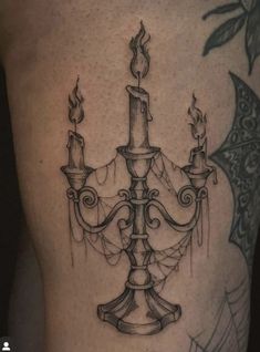 a black and white photo of a chandelier tattoo