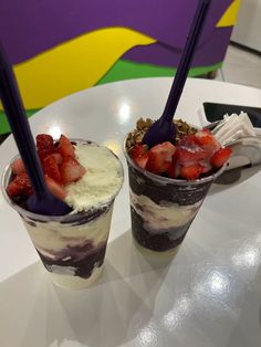 two dessert cups with strawberries and whipped cream