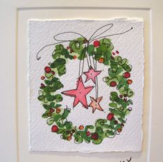 a christmas wreath with three stars hanging from it