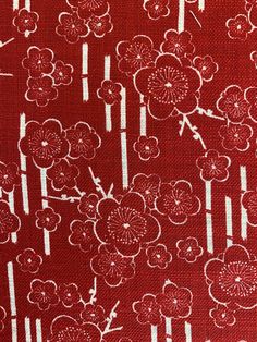 a red background with white flowers and arrows