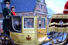 a horse drawn carriage with two men in uniform