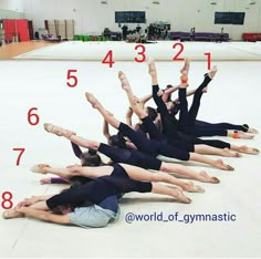 a group of women doing yoga poses on the floor with their hands in the air