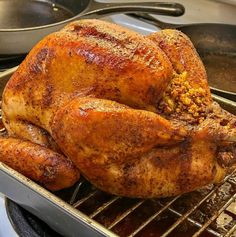 a roasted turkey sitting on top of a grill