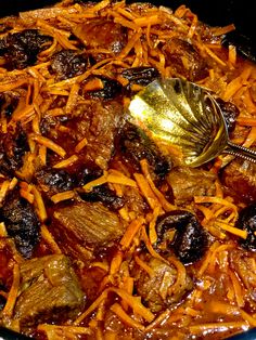 a close up of food in a pan with a spoon on top of the dish