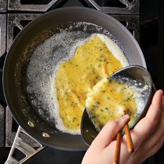 someone is cooking food in a pan on the stove