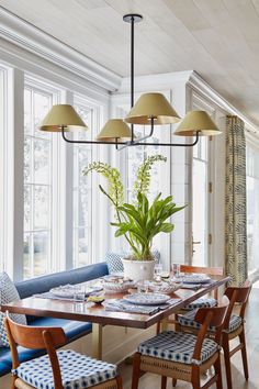 a dining room table with blue and white chairs