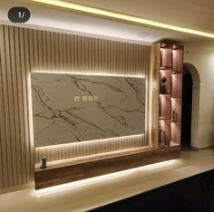 a living room with a large marble wall in the center and built - in shelving