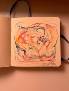 an open book with a drawing on the front and back cover in pastel colors