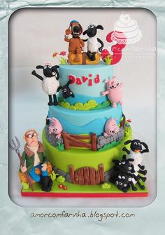 a three tiered cake decorated with farm animals