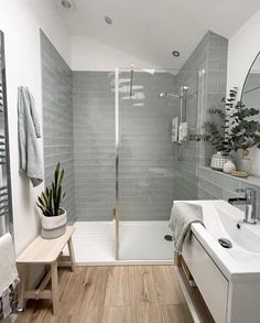 a bathroom with a shower, sink and bathtub in the corner next to a mirror