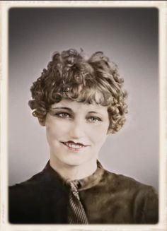 an old photo of a woman with curly hair