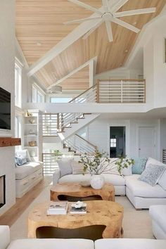 a living room filled with furniture and a flat screen tv on top of a wooden table