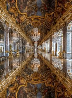 an ornate room with chandeliers and paintings on the walls