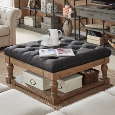 a coffee table with a magazine on it in a living room next to a couch