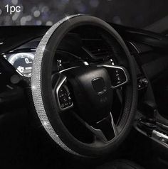 the interior of a car with black leather and chrome trims, including steering wheel