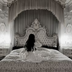 a woman sitting on top of a bed in a bedroom