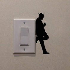 a wall mounted light switch with a silhouette of a man