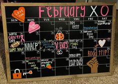 a chalkboard calendar with stickers on it in front of a carpeted floor