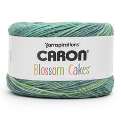 yarn that is green and blue, with the words carbon blossom cakes written on it