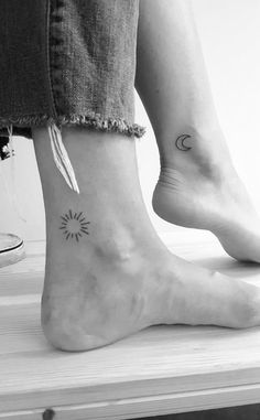 two people with matching tattoos on their feet, one has a sun and the other has a moon