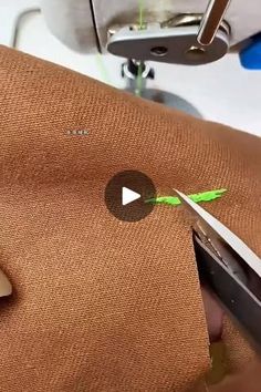 someone is cutting fabric with scissors on a sewing machine