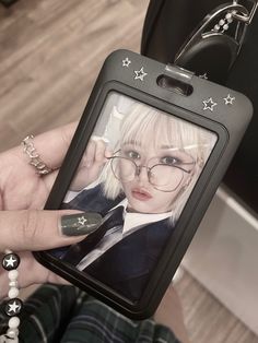 a person holding up a cell phone with a picture on it