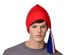 Simple red phrygian style cap.  This  hat has a handtied red white and blue tassel made of yarn. A traditional liberty cap, symbolizing freedom and liberty going back into ancient history. Phrygian hat's have an ancient history of being the symbol of liberty and freedom.   The phrygian hat is used in the seal of several states and is in the seal of the US senate. Start a revolution. This hat is made from fleece.  Machine washable. Long red, white and blue tassel on point. Made from soft fleece. Us Senate, Hat Base, Blue Tassel, Fabric Bolts, Long Red, Costume Hats, Cotton Velvet, Mascot Costumes, Knit Cotton