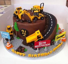 a birthday cake decorated with construction vehicles and road signs