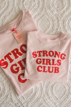 *We are waiting for a replenishment of stock which should be with us by the 8th July. Thank you for your patience as there my be a slight delay in delivery. Biggest of thanks to Luluah for wearing her Strong Girls Club tee and getting it signed by Venus Williams, and to Wimbledon for covering the moment!* Join the Strong Girls Club. The updated original pink and red Strong Girls Club slogan tshirt in our best-selling dipped hem shape. Carbonised cotton for a soft and plush hand feel. Centre back Slogan Tshirt, Boom Boom, Strong Girls, Girls Club, Pink Tshirt, Soft Pink, Pilates, Shirt Designs, Organic Cotton