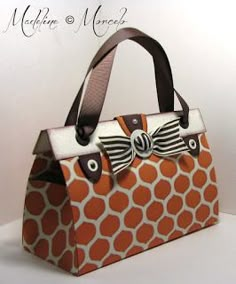 an orange and white bag with a bow on it