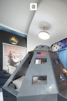 the space shuttle is on display in this museum like room with blue walls and white ceiling