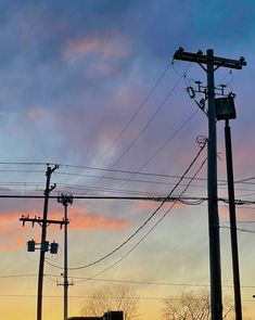 power lines and telephone poles against a sunset sky