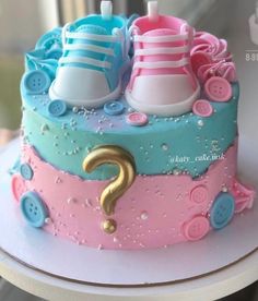 there is a cake decorated with baby shoes