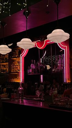 a dimly lit bar with lights hanging from the ceiling