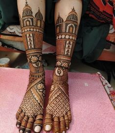 the feet are decorated with henna and intricate designs on it's legs, which is