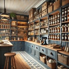 an old fashioned kitchen with blue cabinets and shelves filled with jars, pans and other items