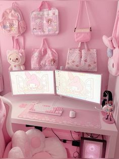 a pink desk with two computer monitors on it